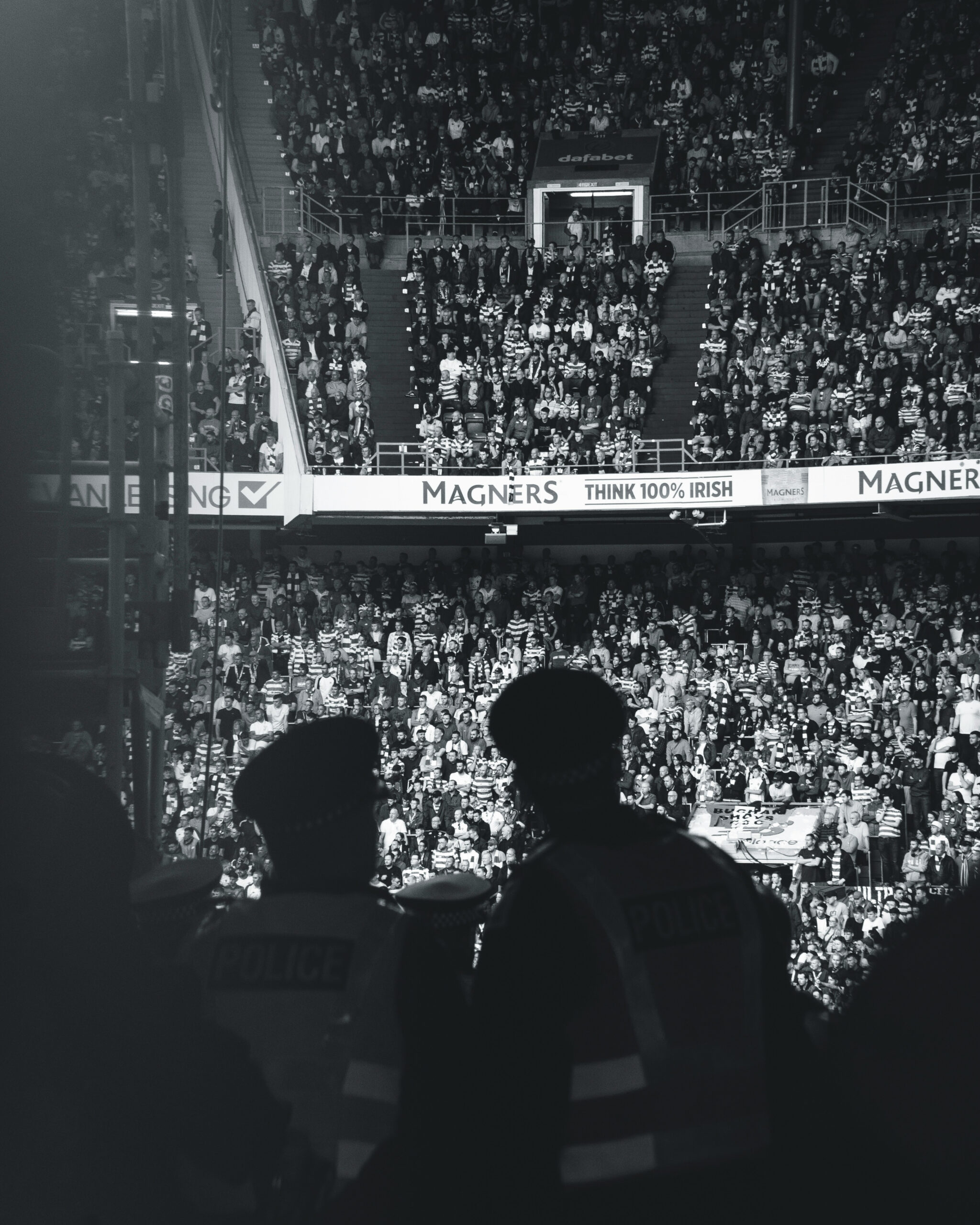 People watching a football match, black and white photograph.