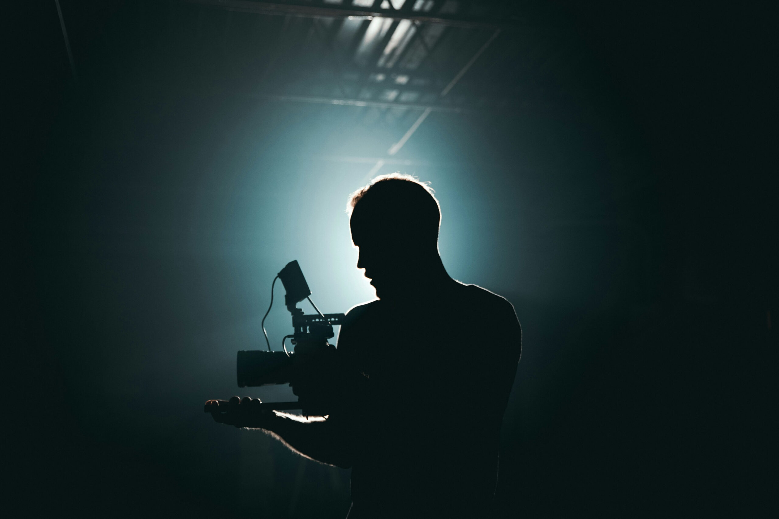 Camera person in a dark room, backlit